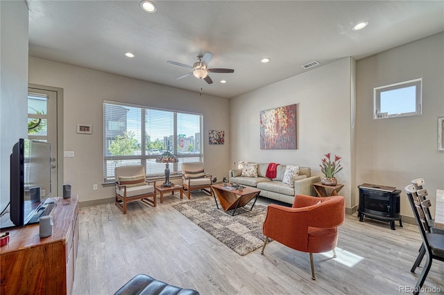 1139 Agate Ln, Poncha Springs, CO 81242 - living room with a wood stove, light wood-style floors, a ceiling fan, recessed lighting, and baseboards