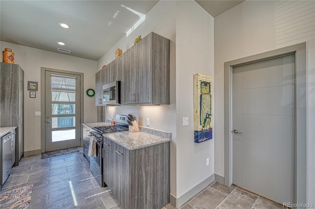 1139 Agate Ln, Poncha Springs, CO 81242 - kitchen featuring stainless steel appliances, baseboards, light stone finish flooring, light stone countertops, and recessed lighting