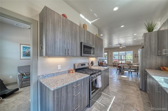 1139 Agate Ln, Poncha Springs, CO 81242 - kitchen featuring appliances with stainless steel finishes, modern cabinets, recessed lighting, ceiling fan, and light stone counters