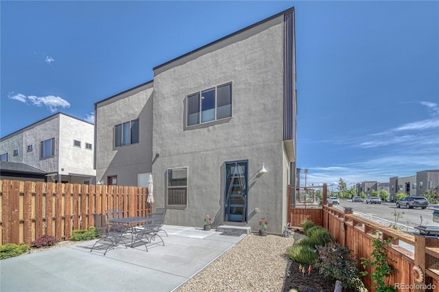 1139 Agate Ln, Poncha Springs, CO 81242 - back of property featuring a fenced backyard, stucco siding, and a patio area