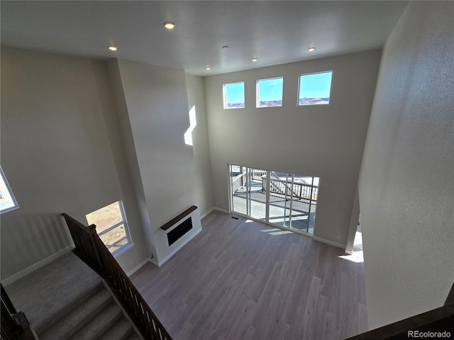 unfurnished living room featuring dark wood-type flooring and heating unit