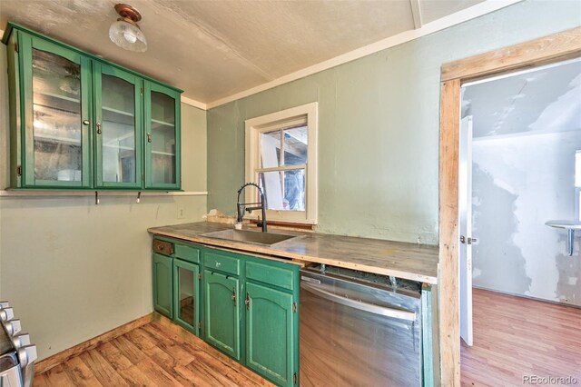 kitchen featuring dishwasher, light wood-type flooring, green cabinets, and sink