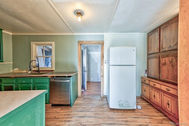 kitchen featuring white refrigerator, crown molding, sink, stainless steel dishwasher, and light wood-type flooring