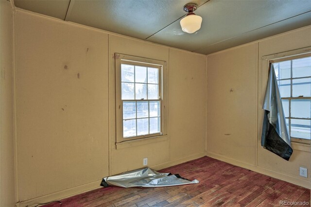 unfurnished room with wood-type flooring