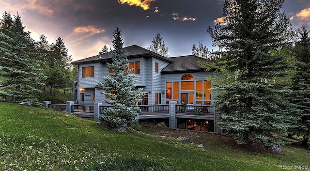 2191 Baldy Ln, Evergreen, CO 80439 - back of house at dusk with a lawn and a wooden deck