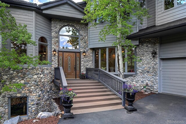 2191 Baldy Ln, Evergreen, CO 80439 - view of exterior entry with stone siding and a garage