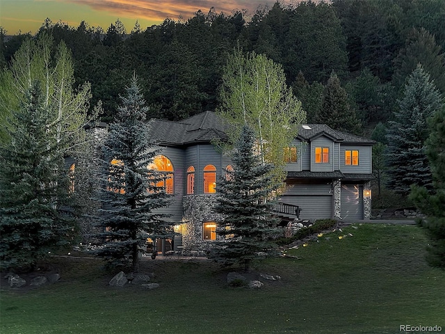 2191 Baldy Ln, Evergreen, CO 80439 - view of front facade with a garage, a lawn, and a forest view