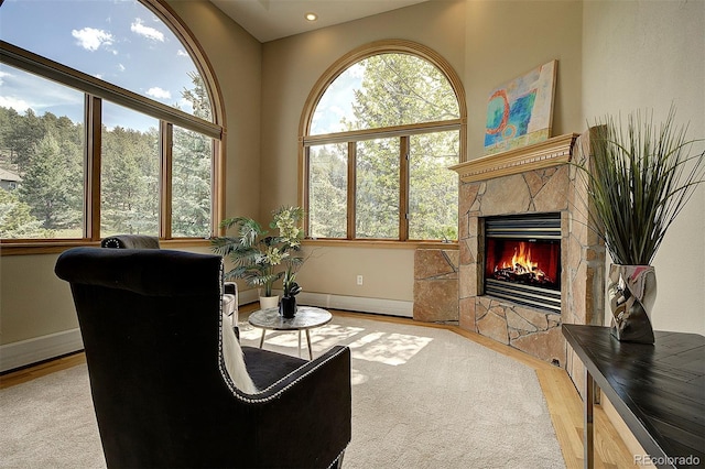 2191 Baldy Ln, Evergreen, CO 80439 - living area with wood finished floors, a stone fireplace, and recessed lighting