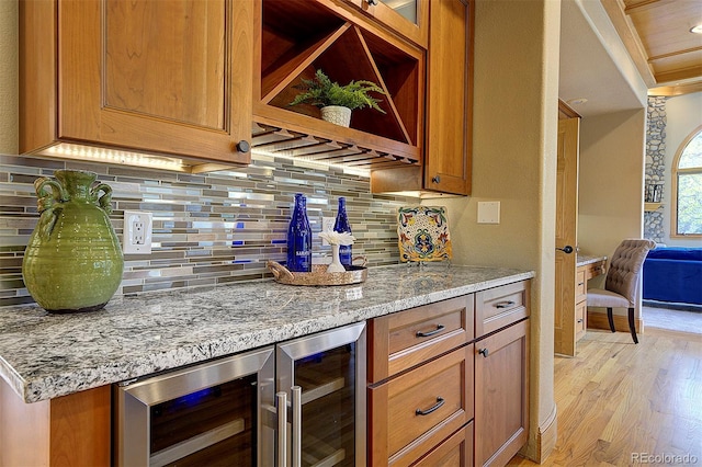 2191 Baldy Ln, Evergreen, CO 80439 - indoor dry bar featuring beverage cooler, light wood-style flooring, and decorative backsplash