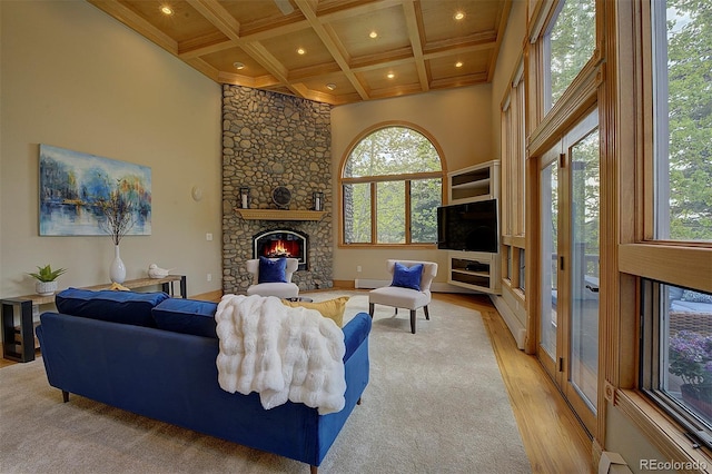 2191 Baldy Ln, Evergreen, CO 80439 - living area with plenty of natural light, light wood finished floors, a fireplace, beamed ceiling, and coffered ceiling