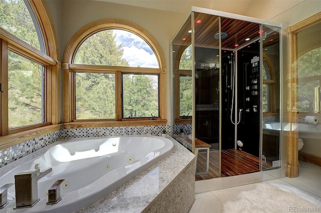 2191 Baldy Ln, Evergreen, CO 80439 - bathroom featuring tile patterned floors, a tub with jets, and a shower stall