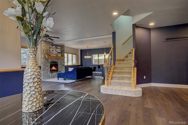 2191 Baldy Ln, Evergreen, CO 80439 - entrance foyer featuring wood finished floors, a stone fireplace, stairs, ceiling fan, and recessed lighting