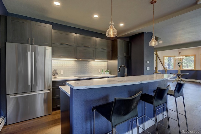 2191 Baldy Ln, Evergreen, CO 80439 - kitchen featuring freestanding refrigerator, wood finished floors, recessed lighting, tasteful backsplash, and black electric stovetop