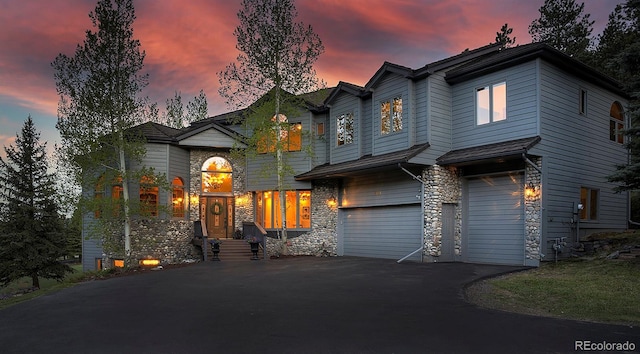 2191 Baldy Ln, Evergreen, CO 80439 - view of front of property with a garage, stone siding, and driveway