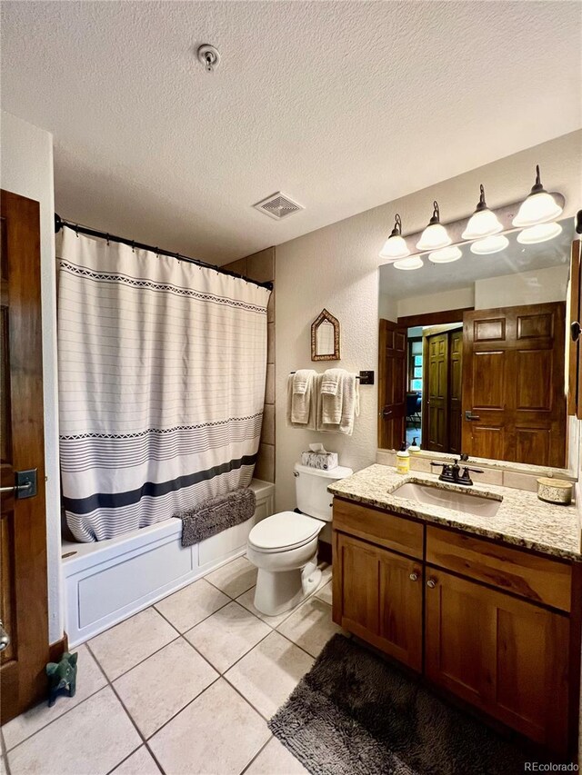 2104 Blue Sky Trl Unit 2-104, Granby, CO 80446 - bathroom with vanity, shower / bath combo with shower curtain, a textured ceiling, and tile patterned flooring