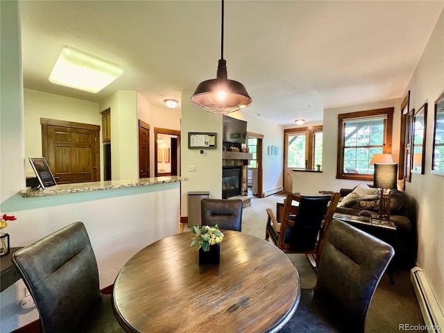 2104 Blue Sky Trl Unit 2-104, Granby, CO 80446 - carpeted dining area with a baseboard radiator, a glass covered fireplace, and baseboard heating