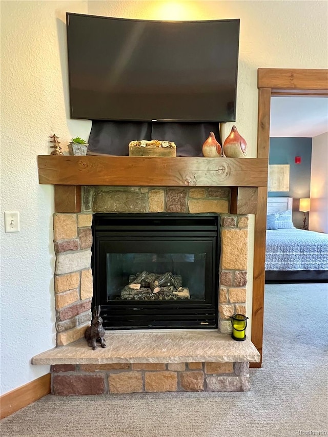 2104 Blue Sky Trl Unit 2-104, Granby, CO 80446 - detailed view of carpet flooring, a stone fireplace, and a textured wall