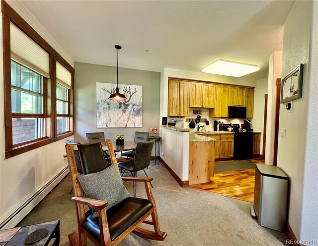 2104 Blue Sky Trl Unit 2-104, Granby, CO 80446 - kitchen with black appliances, a baseboard radiator, light carpet, a peninsula, and hanging light fixtures