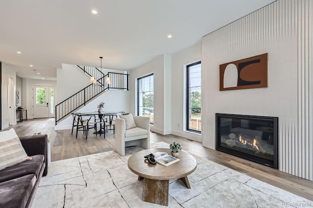 3019 Chase St, Wheat Ridge, CO 80214 - living area featuring stairs, wood finished floors, recessed lighting, baseboards, and a glass covered fireplace