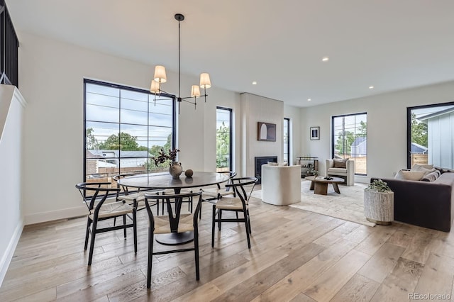 3019 Chase St, Wheat Ridge, CO 80214 - dining area with light wood-type flooring, a chandelier, a fireplace, baseboards, and recessed lighting