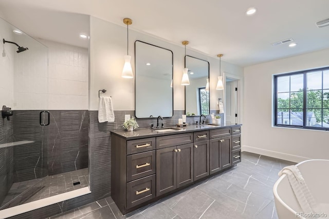 3019 Chase St, Wheat Ridge, CO 80214 - full bathroom featuring double vanity, a shower stall, a freestanding tub, recessed lighting, and baseboards