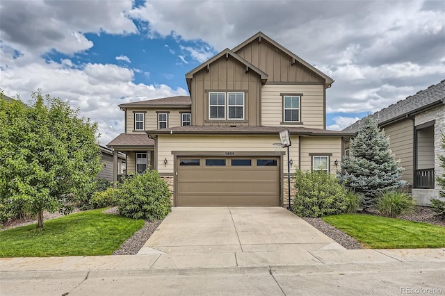 craftsman inspired home with board and batten siding, concrete driveway, a front lawn, and a garage