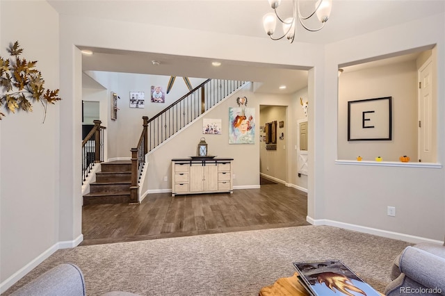 living area featuring a chandelier, wood finished floors, carpet flooring, baseboards, and stairs