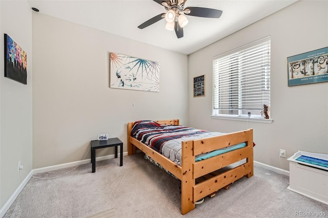 carpeted bedroom featuring ceiling fan and baseboards