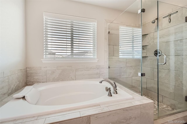 bathroom with a garden tub and a shower stall