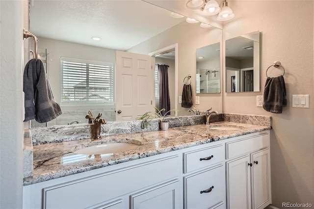 full bathroom featuring double vanity and a sink