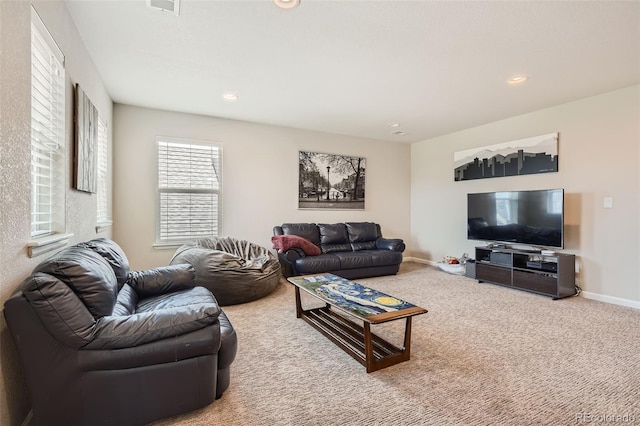 carpeted living area featuring visible vents, baseboards, and recessed lighting