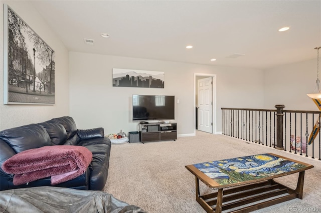 carpeted living room featuring baseboards, visible vents, and recessed lighting