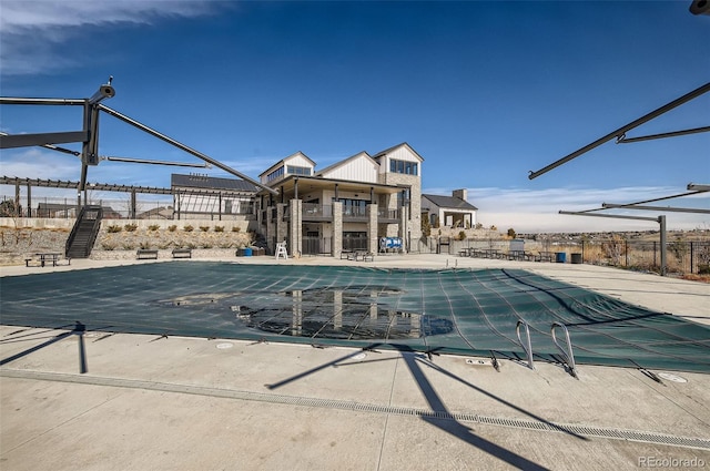 pool featuring a patio area and fence