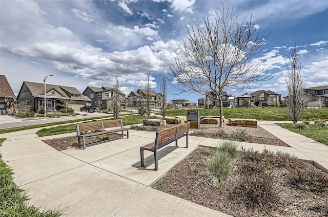 view of community featuring a residential view and a yard