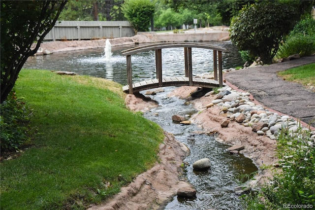 view of pool featuring a water view