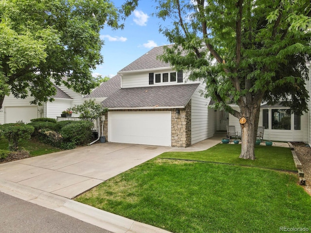 view of front of property with a front yard and a garage