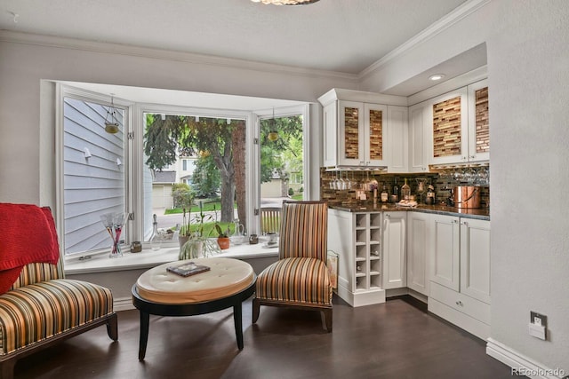 living area featuring a textured ceiling, dark hardwood / wood-style flooring, and crown molding