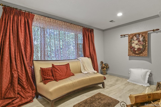 sitting room featuring light hardwood / wood-style floors and ornamental molding