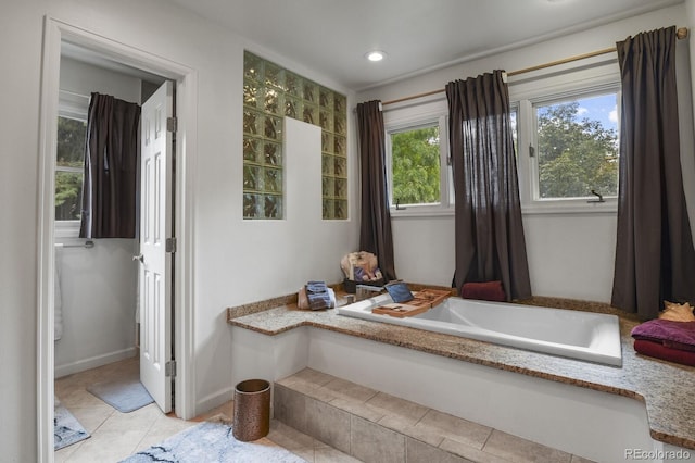 bathroom featuring tile patterned floors and tiled tub