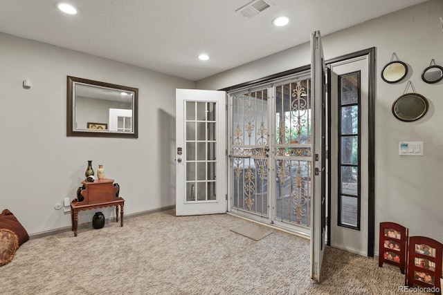 doorway to outside with carpet flooring and french doors