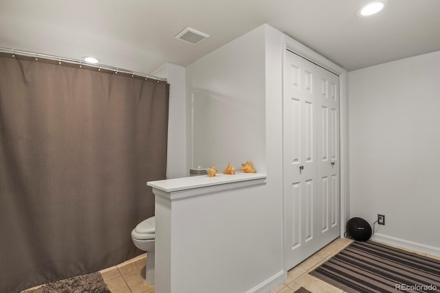 bathroom featuring tile patterned flooring and toilet