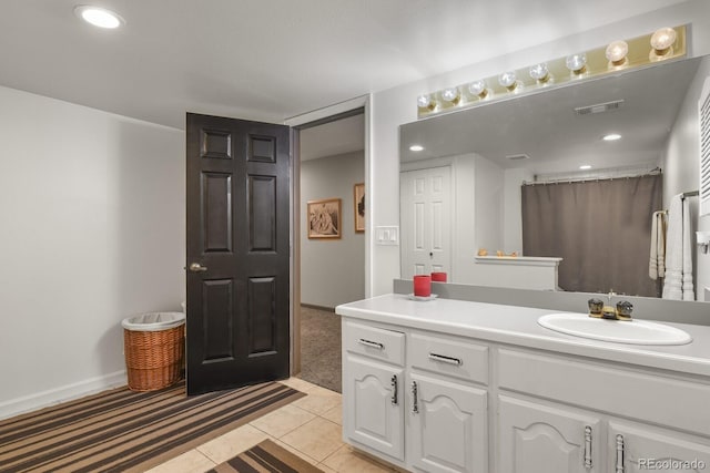 bathroom with tile patterned floors, vanity, and walk in shower