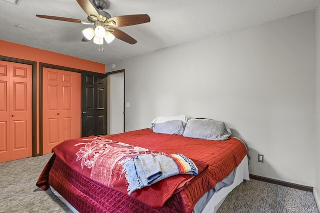 carpeted bedroom with a textured ceiling and ceiling fan