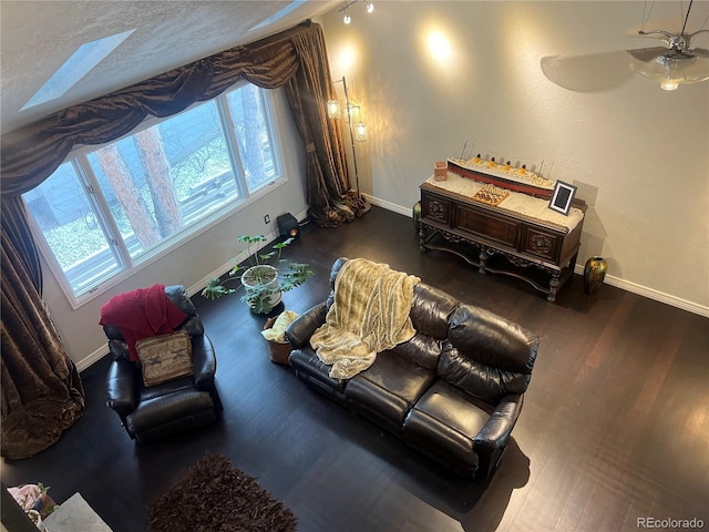 living area featuring hardwood / wood-style floors, a textured ceiling, and ceiling fan