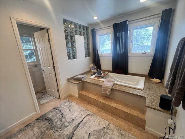 bathroom featuring tile patterned flooring and a tub