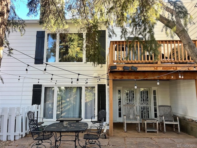 rear view of house with a balcony and a patio