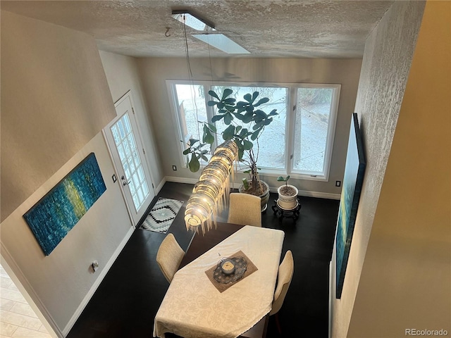 dining area featuring a textured ceiling