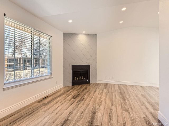 unfurnished living room featuring a fireplace, baseboards, wood finished floors, and recessed lighting