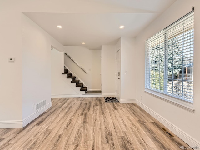 entrance foyer featuring recessed lighting, visible vents, wood finished floors, baseboards, and stairs