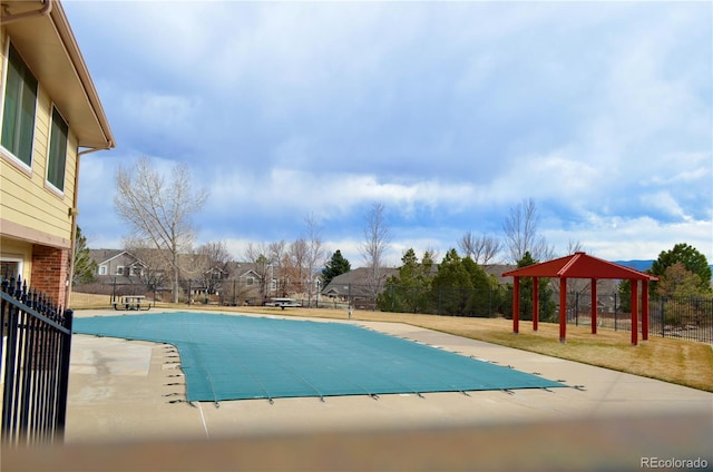 pool with a gazebo, a patio area, and fence